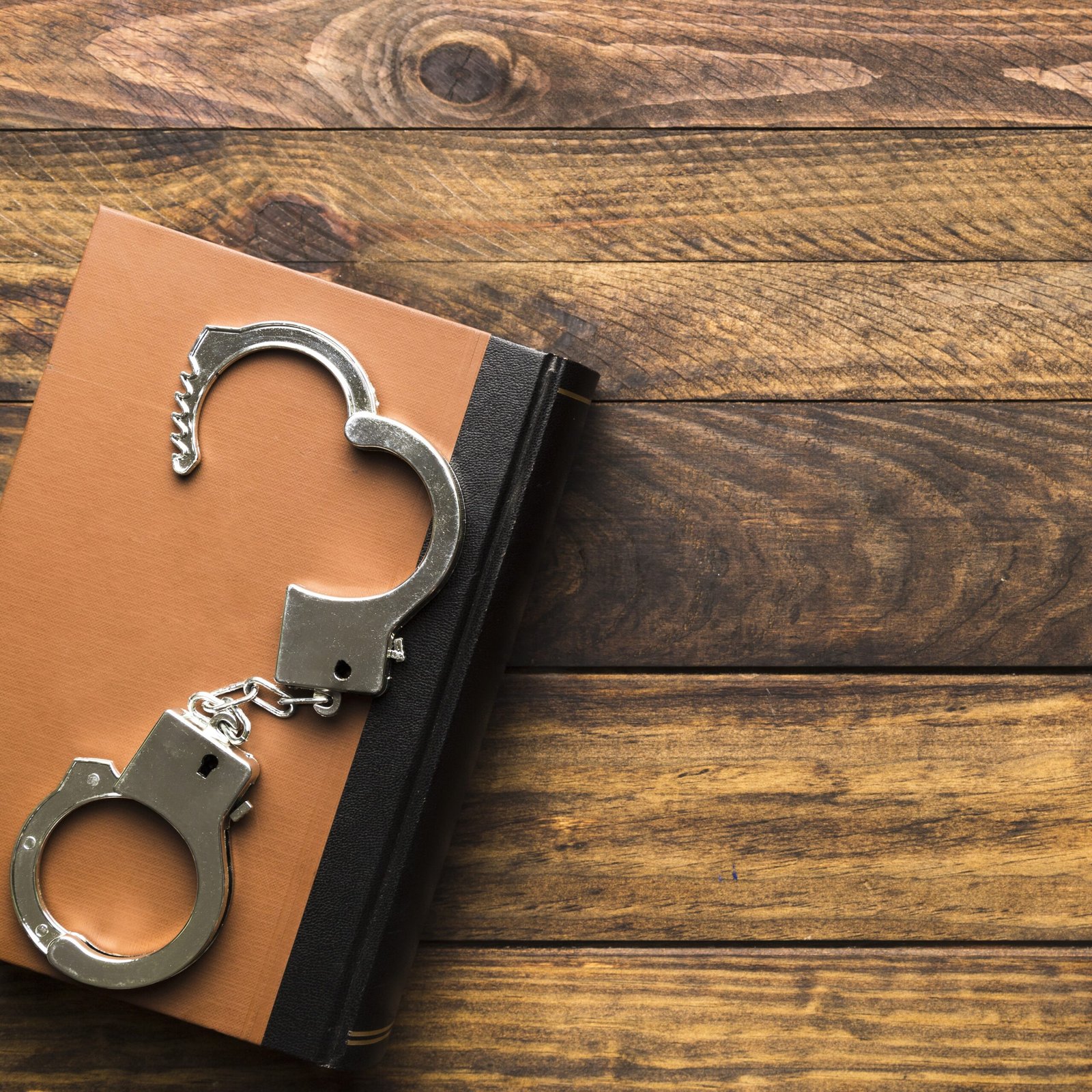 flat-lay-frame-with-book-handcuffs